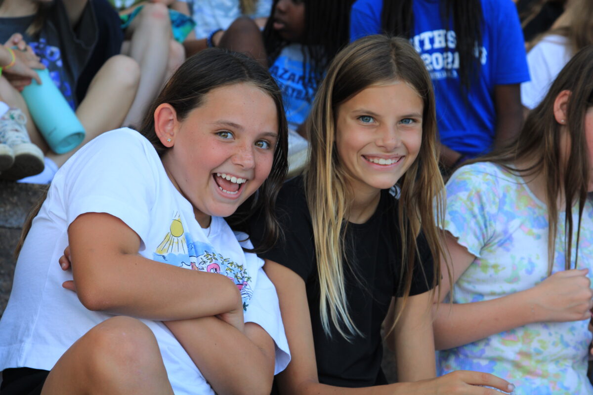 Two young girls posing together for a photo at Camp Crosley.