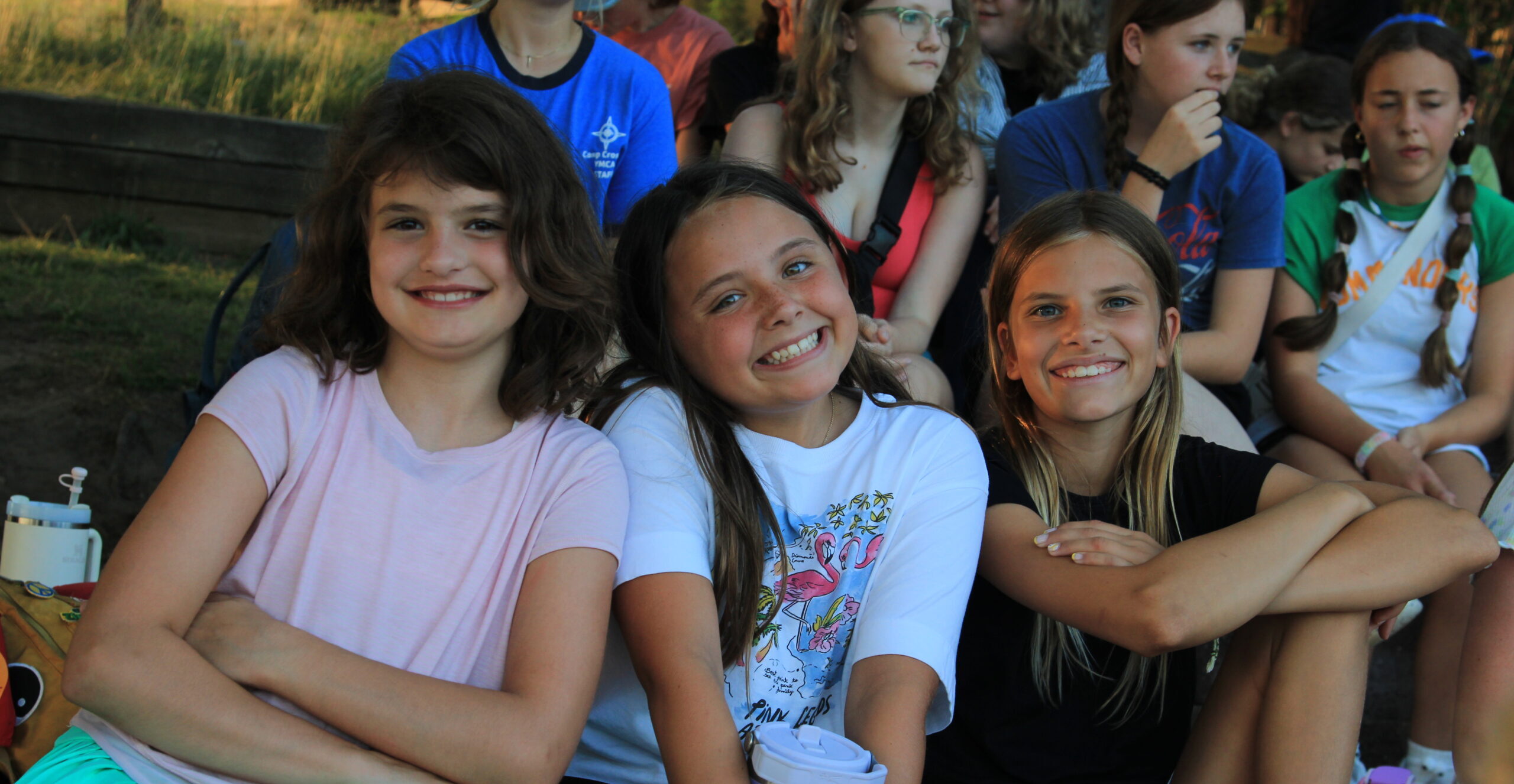 Three young, female campers posing together for a photo.