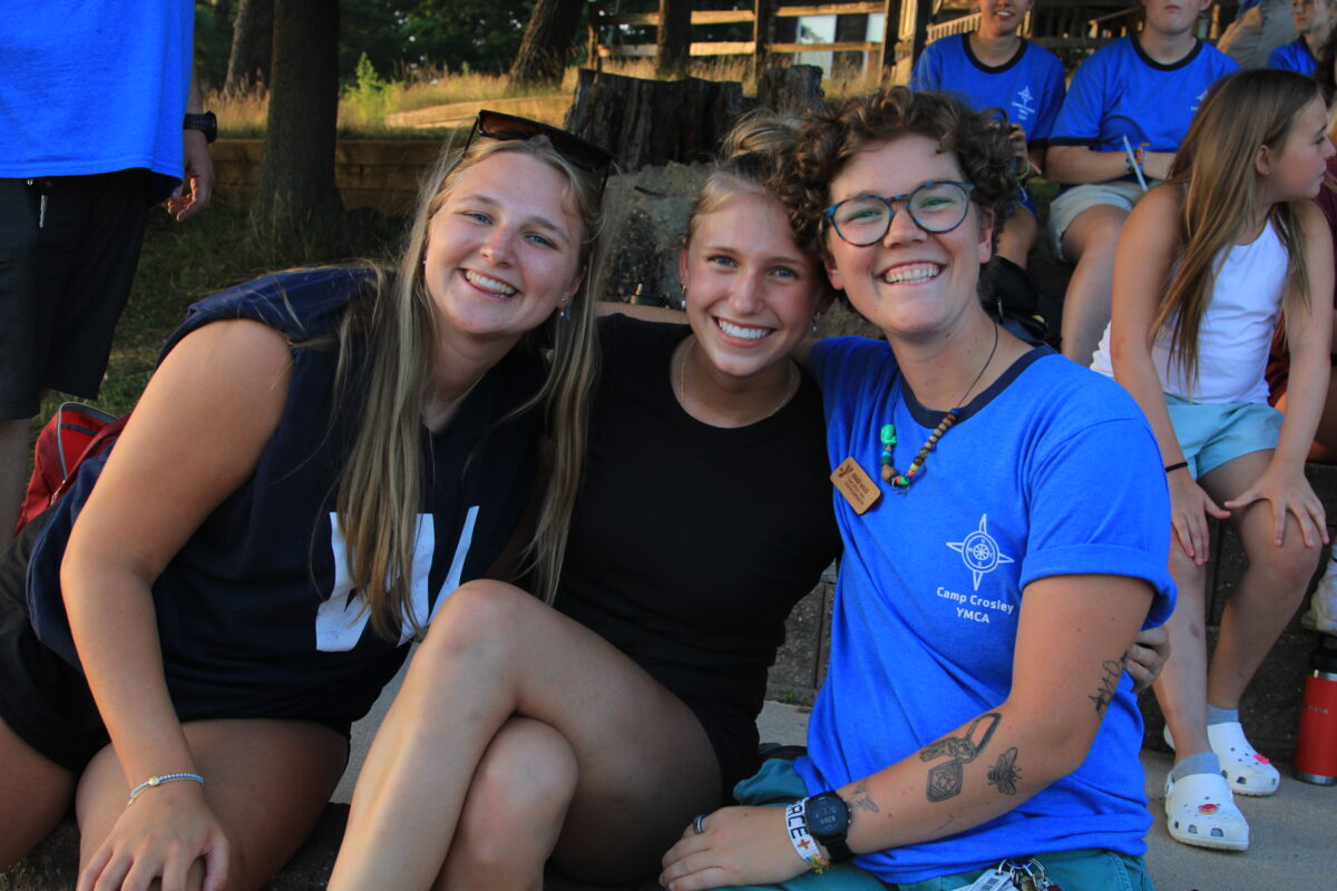 Photo of three camp counselors posing together.